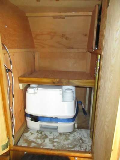 porta pottie and shelf in large closet.jpg