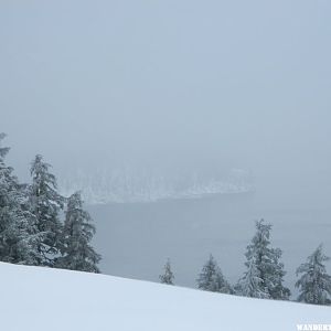 Limited view of Crater Lake and Wizard Island.