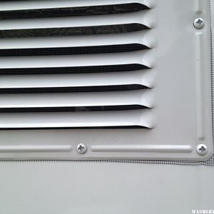 screen behind upper fridge vent