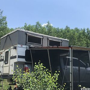 Granby camper popped up with awning and screen room