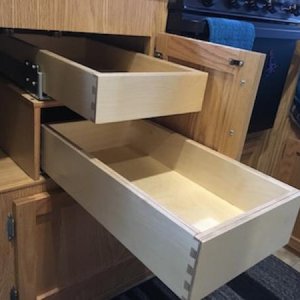 I wanted to have the oven in my 19, but it lacked silverware drawers, so I added two drawers under the sink.  Came out great, they are full extension 