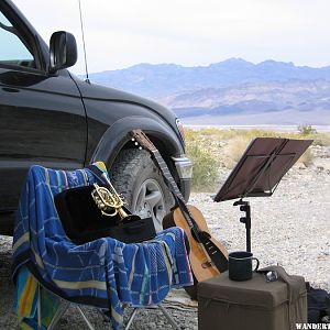 Practicing the horn and guitar in remote canyon