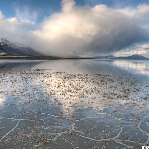 Wet cracks, water, and cloud with mountain