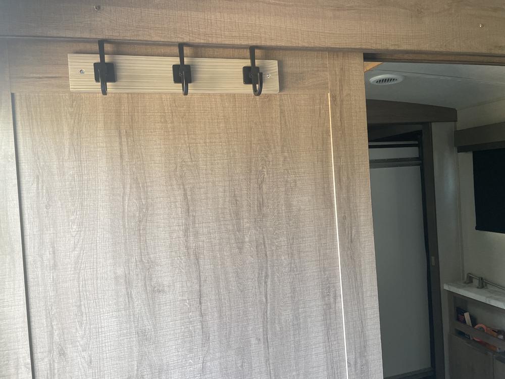 Coat hook mounted on bedroom slider