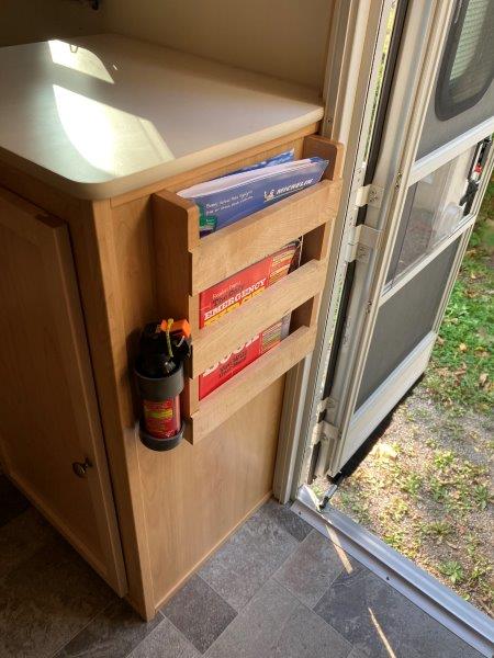 our !7B has the maple interior, I made a small shelf by the door for maps etc.
Also holds a can of bear spray.