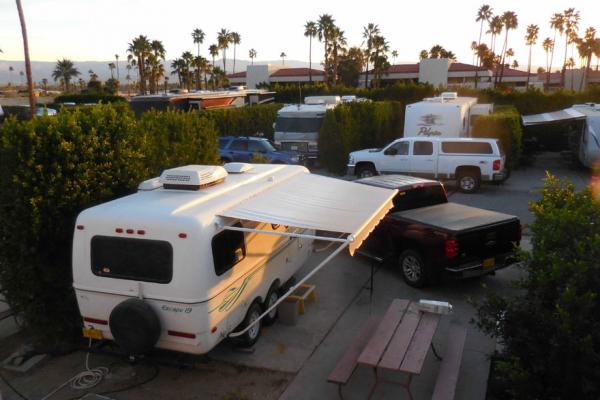 Snugly parked between the hedges at Palm Springs, CA Happy Traveler RV Park