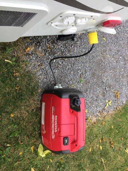 the little Honda generator runs the original 11,000 BTU AC without a problem
Fortunately we have never used it. We live in Canada so the AC has only b