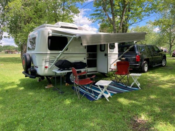 The manual awning allows one corner to be dipped down so any rain or dew runs off to one end. The griddle and BBQ are ready for breakfast. The coffee 