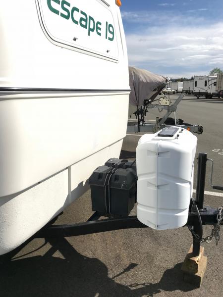 Two new 6 volt batteries, two propane tanks, solar trickle charger.